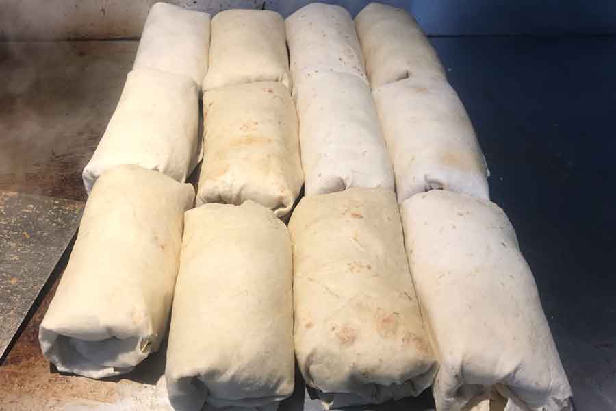 Cheesesteak wraps catering order on grill