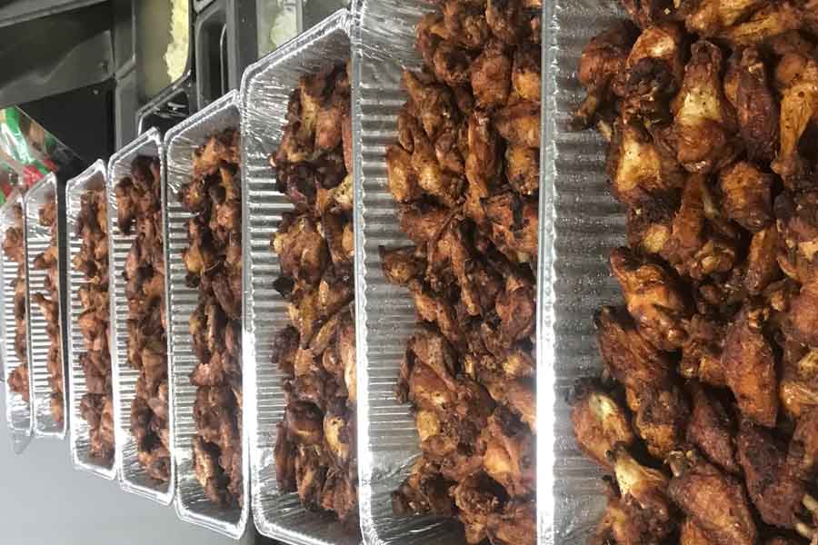 Large 8 trays of wings catering order on counter